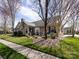 Charming single-Gathering home featuring a stone facade, mature landscaping, and a cozy front patio at 864 Ledgestone Ct, Fort Mill, SC 29708
