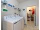 Functional laundry room includes washer, dryer, and shelving for organized storage at 864 Ledgestone Ct, Fort Mill, SC 29708