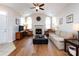 Bright living room featuring hardwood floors, vaulted ceiling, fireplace, and an open layout at 864 Ledgestone Ct, Fort Mill, SC 29708