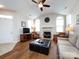 Bright living room featuring hardwood floors, vaulted ceiling, fireplace, and comfortable seating at 864 Ledgestone Ct, Fort Mill, SC 29708