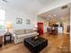 Spacious living room seamlessly connecting to the dining area and kitchen with beautiful hardwood floors at 864 Ledgestone Ct, Fort Mill, SC 29708