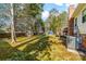 Large backyard featuring mature trees, a storage shed, and a deck at 9624 Buckskin Ln, Mint Hill, NC 28227
