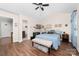 Charming bedroom features a ceiling fan, wood floors, and a cozy bench at 9624 Buckskin Ln, Mint Hill, NC 28227