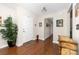 Inviting foyer with gleaming hardwood floors, large potted plant, and coat closet at 9624 Buckskin Ln, Mint Hill, NC 28227