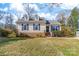 Charming one-story home with well-maintained lawn and inviting front entrance with dark shutters and colorful front door decor at 9624 Buckskin Ln, Mint Hill, NC 28227