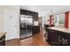 Modern kitchen features stainless steel refrigerator, dark cabinets, hardwood floors and granite countertops at 9624 Buckskin Ln, Mint Hill, NC 28227