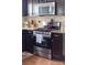This modern kitchen offers stainless steel appliances, granite countertops and dark cabinets at 9624 Buckskin Ln, Mint Hill, NC 28227