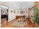 Bright office with tray ceiling, hardwood floors, a colorful rug, and adjacent kitchen at 9624 Buckskin Ln, Mint Hill, NC 28227