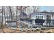 Backyard featuring a well-kept deck, a patio with a gazebo, steps leading down to lake access, and a shed at 112 Trestle Cir, New London, NC 28127