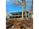 Backyard with staircase leading to the lake and a large deck on the house at 112 Trestle Cir, New London, NC 28127