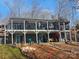 Two-story lake house with a multi-tiered deck and easy access to the lake at 112 Trestle Cir, New London, NC 28127