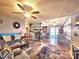 Inviting living room with ceiling fan and large rug that leads to the well-lit gathering room and kitchen at 112 Trestle Cir, New London, NC 28127
