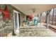 Covered stone patio perfect for outdoor living and enjoying the surrounding natural beauty at 112 Trestle Cir, New London, NC 28127