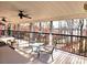Covered porch featuring seating with a view of the surrounding trees and lake at 112 Trestle Cir, New London, NC 28127