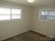 Bedroom featuring neutral paint, carpet and two windows at 1138 Choyce Ave, Charlotte, NC 28217