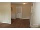View of a room with a doorway, light beige walls, door to the backyard and wood flooring at 1138 Choyce Ave, Charlotte, NC 28217