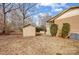 Back exterior featuring a shed and landscaped greenery at 1142 Canterbury Dr, Lancaster, SC 29720