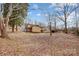 Spacious backyard featuring a deck and patio with mature trees at 1142 Canterbury Dr, Lancaster, SC 29720