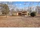 Exterior featuring a back deck and patio with mature trees at 1142 Canterbury Dr, Lancaster, SC 29720