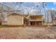 Exterior of home featuring a back deck with a covered patio, an expansive yard, and mature trees at 1142 Canterbury Dr, Lancaster, SC 29720