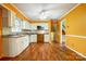 Open concept, orange kitchen with wood laminate flooring and plenty of counter space at 1142 Canterbury Dr, Lancaster, SC 29720