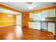 Open concept, orange kitchen with wood laminate flooring and plenty of counter space at 1142 Canterbury Dr, Lancaster, SC 29720