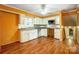 Open concept, orange kitchen with wood laminate flooring and plenty of counter space at 1142 Canterbury Dr, Lancaster, SC 29720