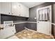 Laundry room featuring overhead storage and side door at 1142 Canterbury Dr, Lancaster, SC 29720