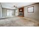 Spacious living room featuring a brick fireplace and double doors to outside at 1142 Canterbury Dr, Lancaster, SC 29720