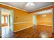 Bright living room showcasing hardwood floors, white trim, and a modern ceiling fan at 1142 Canterbury Dr, Lancaster, SC 29720