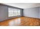 Neutral Living Room with Wood Laminate Flooring and Plenty of Natural Light at 1142 Canterbury Dr, Lancaster, SC 29720