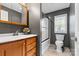 Stylish bathroom with gray walls, modern vanity, and a shower-tub combination with a window at 117 Pine Bluff Dr, Mooresville, NC 28117