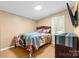 Bright bedroom with wood floors, natural light, and dark wood furniture for a modern look at 117 Pine Bluff Dr, Mooresville, NC 28117