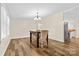 Dining room showcases the wood flooring and is staged with modern furniture at 117 Pine Bluff Dr, Mooresville, NC 28117