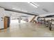 Large garage with storage shelving and an open garage door to the property's backyard at 117 Pine Bluff Dr, Mooresville, NC 28117