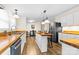 Bright eat-in kitchen features butcher block counters, wood floors, and stainless steel appliances at 117 Pine Bluff Dr, Mooresville, NC 28117