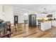 Open-concept living space seamlessly connects to the kitchen with sleek appliances and hardwood flooring at 117 Pine Bluff Dr, Mooresville, NC 28117