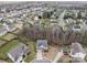 Elevated view of a home with landscaping within a friendly neighborhood surrounded by verdant trees at 12302 Volusia Ct, Charlotte, NC 28262
