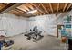 Unfinished basement space with exposed ceiling, workout equipment, and ready for customization at 12302 Volusia Ct, Charlotte, NC 28262