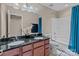 Neutral bathroom with double sinks, black countertop, and a tub/shower combo at 12302 Volusia Ct, Charlotte, NC 28262