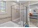 Bathroom featuring a walk-in shower with glass doors, a soaking tub, and neutral tile at 12302 Volusia Ct, Charlotte, NC 28262