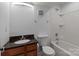 Full bathroom with a dark wood vanity, tub, tile flooring, and bright lighting at 12302 Volusia Ct, Charlotte, NC 28262