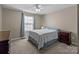 Comfortable bedroom with a ceiling fan, blue accents, and carpet flooring at 12302 Volusia Ct, Charlotte, NC 28262