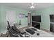 Spacious bedroom featuring green walls, dual monitors, and a ceiling fan at 12302 Volusia Ct, Charlotte, NC 28262
