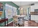 Bright breakfast nook with a round table, four chairs, and a window with natural light at 12302 Volusia Ct, Charlotte, NC 28262