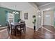 Dining room featuring hardwood floors, a modern chandelier, and large windows for natural light at 12302 Volusia Ct, Charlotte, NC 28262