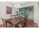 Spacious dining room showcasing a large table, hardwood floors, and a staircase in the background at 12302 Volusia Ct, Charlotte, NC 28262