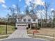 Charming two-story home with blue siding, stone accents, and a well-manicured front yard on a sunny day at 12302 Volusia Ct, Charlotte, NC 28262