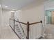 Upstairs hallway featuring a staircase with white spindles and dark wood trim at 12302 Volusia Ct, Charlotte, NC 28262
