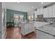 Bright kitchen with white cabinets, granite countertops, and a central island for meal preparation at 12302 Volusia Ct, Charlotte, NC 28262